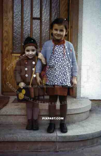 2 girls standing on steps, Germany 1938