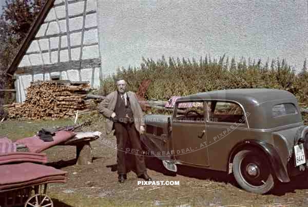 A old grandad standing proudly in his garden beside his DKW F5 Reichsklasse car. Germany 1937.