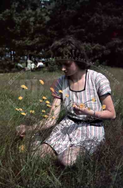 Beautiful woman picking flowers in Berlin Park 1940