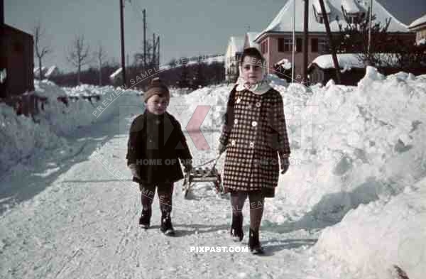 boy and girl pulling sledge, Germany 1942