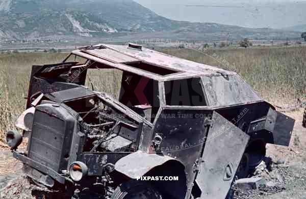 Destroyed captured by Germans, British armored car Morris Commercial C8 FAT in battlefield Greece 1942.