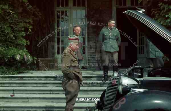 Dutch officer inspecting staff car captured geman officers 1940