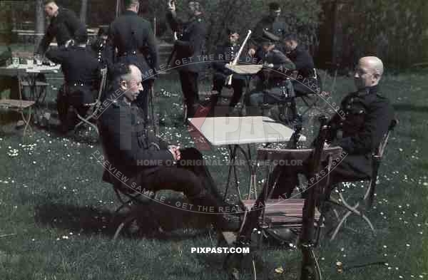 field police drinking beer and resting in garden kar98 rifles black uniforms