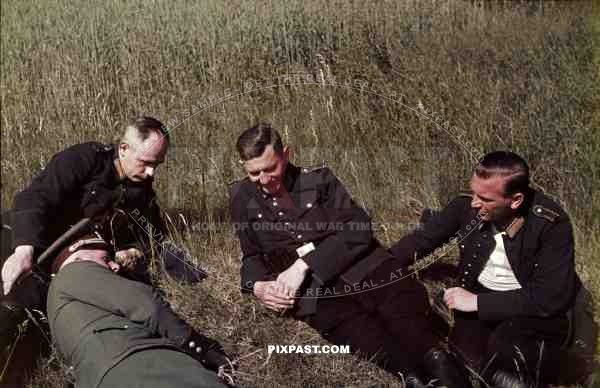 field police uniform black uniform resting in hay field 1939