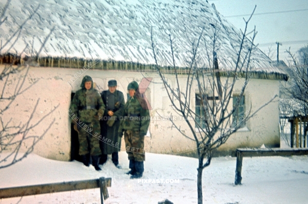 German army officers wearing camouflage uniforms in Ukraine village. Eastern front. Winter 1943.