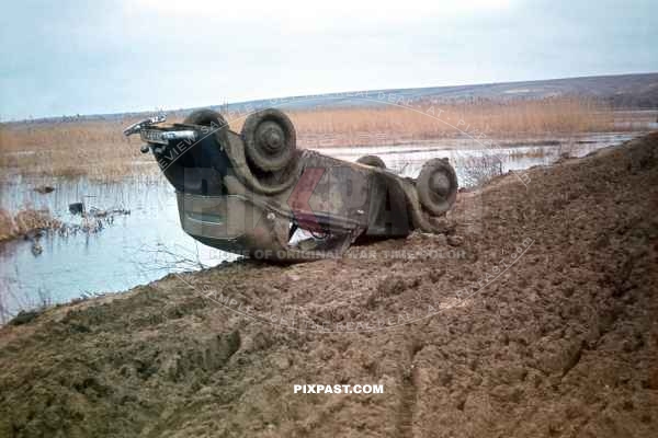 German army staff car tipped on its roof after crash in russian mud field. Russian Front March 1942.