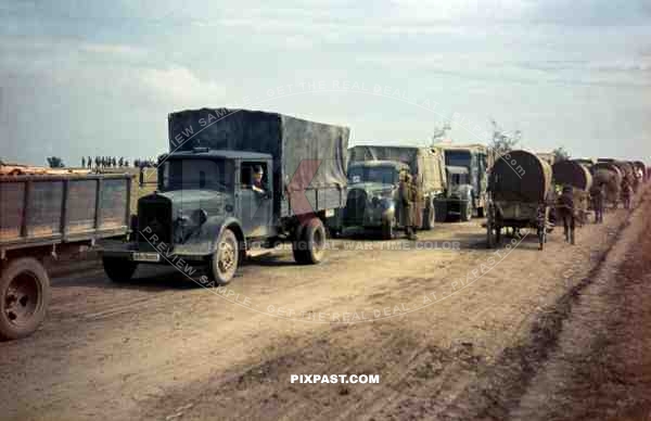 German army supply trucks retreat beside Romanian infantry unit, Russian Front 1944