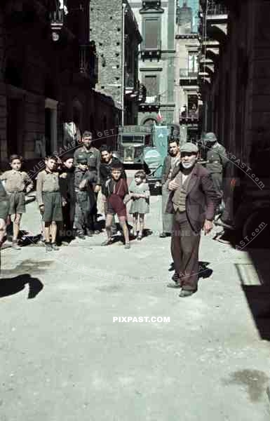 German Luftwaffe soldier personnel street shops car truck lorry helmet children kids grandad poor houses buildings Greece 1942