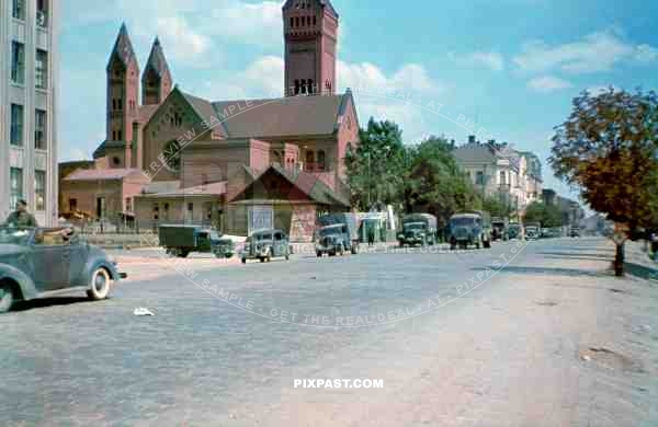 German Luftwaffe unit Luftlotte 2 drive past the Red Church / Church of Saints Simon and Helena in Minsk Belarus 1941.