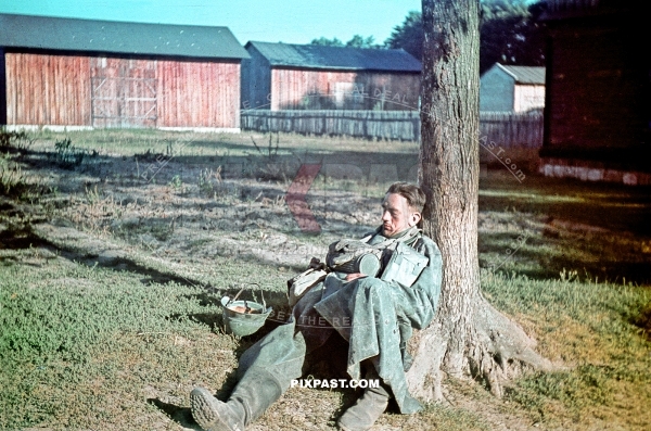 German Wehrmacht Kradmelder Motorbike messenger in rain jacket sleeping in Polish farm. Poland 1939