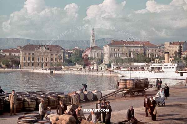 KDF German Ship in Yugoslavian Harbour 1939. Men unloading barrels of wine. Ice cream seller.