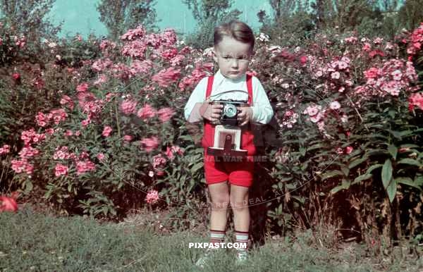Little boy holding his fathers Certo Dollina I camera. Summer 1939 Halle Saale Germany.