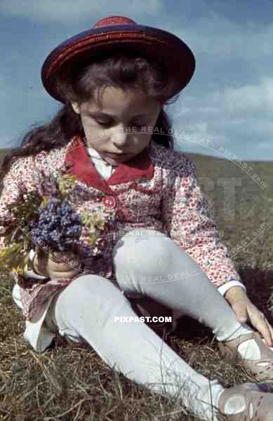 little girl sitting on a field, Germany 1939