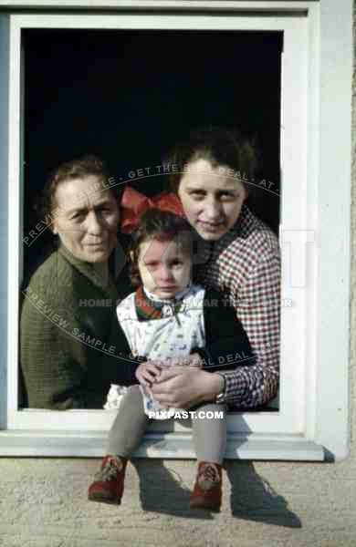 little girl with her mother and grandmother at the window, Germany 1937