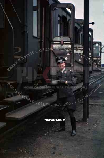 Luftwaffe officer with water bowl at the railway yard in Stendal, Germany 1940 