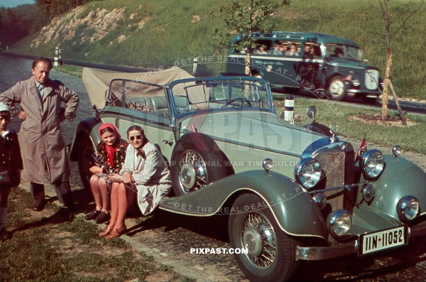 Mercedes-Benz 380 Cabriolet B, Kelheim Germany 1939, with tour bus behind and family resting beside road.