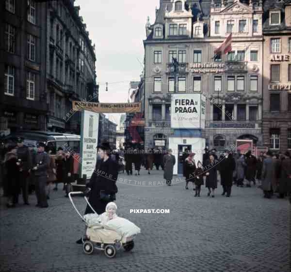 mother with baby in a pram at the market place in Leipzig, Germany 1941