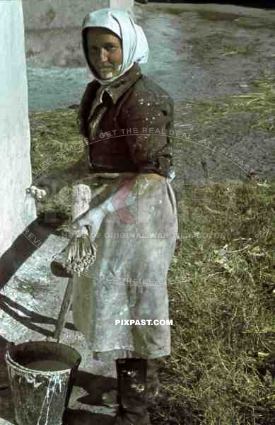 poor ukrainian peasant woman painting house with brush and white paint, Krim, Kretsch, 1942