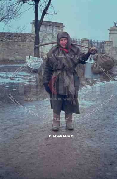 Russian farmer women carrying food and water through Russian village 1943. Photographed by german war photographer.