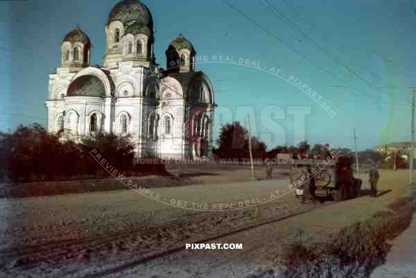 Russian orthodox church near Smolensk summer 1942, German transport truck with soldiers and bicycle.