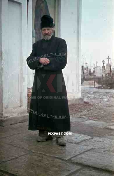 Russian Orthodox priest in front of Church and graveyard, Russia 1942, Taken by German war reporter.