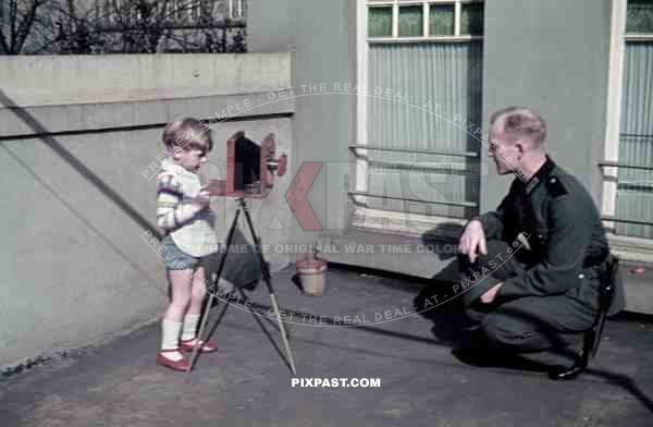 Soldier being photographed by his son in Leipzig, Germany 1940