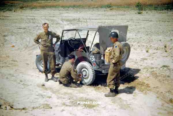 The Blue Devils US 88th Infantry Division  in Italy 1944. Changing the Tyre of an American Willys MB Jeep.