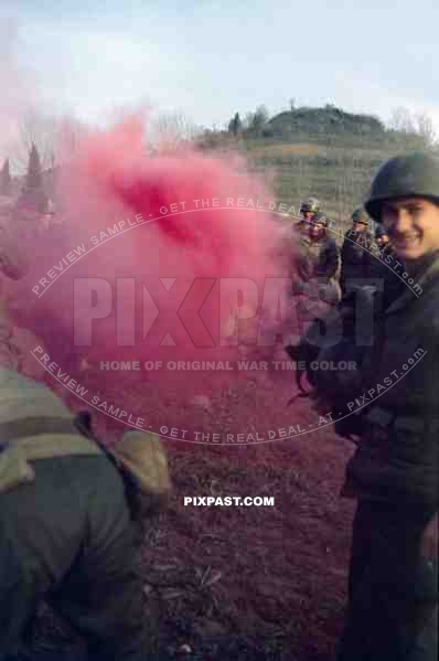 The Blue Devils US 88th Infantry Division training with smoke grenades in Italy 1944. GI holding his captured German helmet