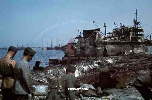 Tripoli harbour in Libya, 1942. Destroyed Burning german transport ships after Allied air attack.