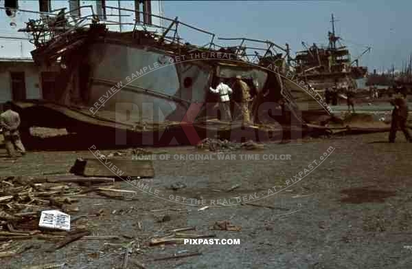 Tripoli harbour in Libya, 1942. Destroyed Burning german transport ships after Allied air attack.