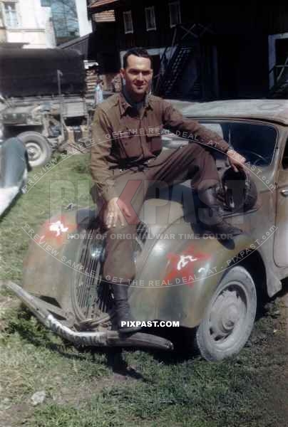 US Army officer of the 101ST CAVALRY REGIMENT. Sitting on a  captured Germany army car Peugot 202. Schwendt Austria 1945