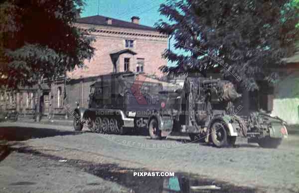 Wehrmacht heavy anti aircraft gun 88mm pulled by heavy halftrack summer town Ukraine 1943
