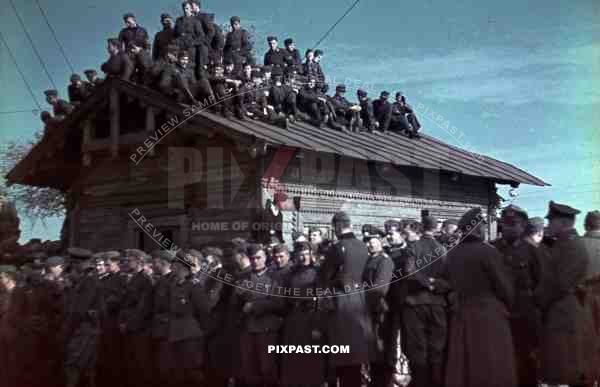 Wehrmacht soldiers sitting on the roof of a cabin in Krementschuk, Ukraine 1941
