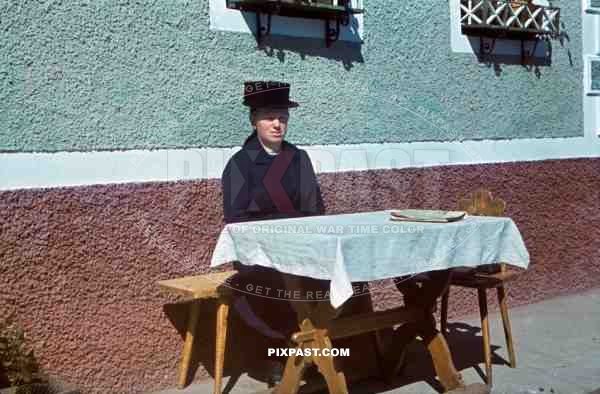 Woman at picnic table wearing traditional German costume. Bonn, Nordrhein-Westfalen, 1939