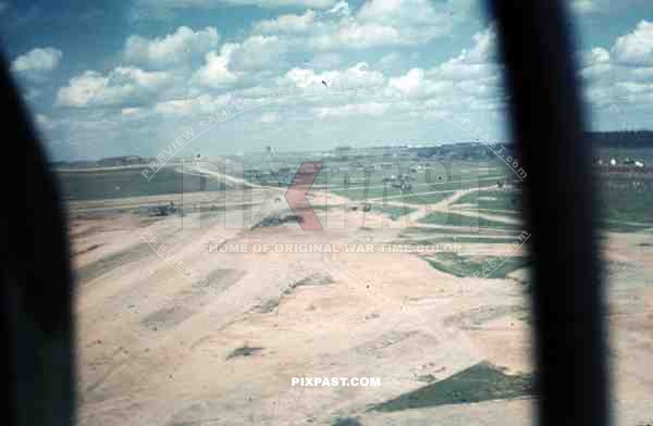 WW2 color Aerial view of bombed Belgium military airbase strip hangers 1940 german petrol trucks,