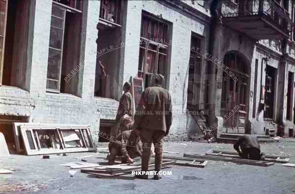 WW2 Color Ukraine Kharkov Russian military POW soldiers repair windows in captured government building for germans