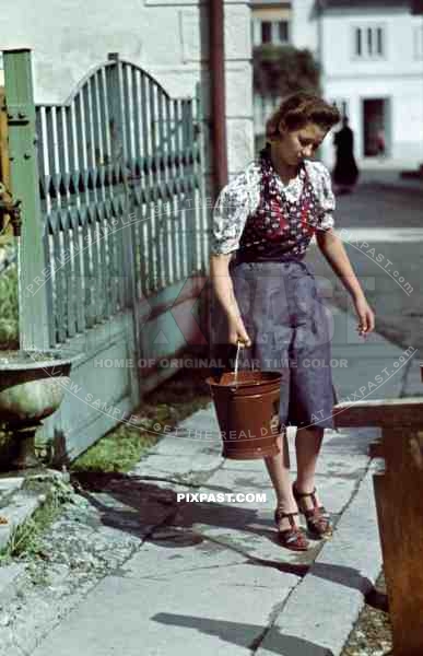Young woman collecting water outside home in Stuttgart Germany 1939