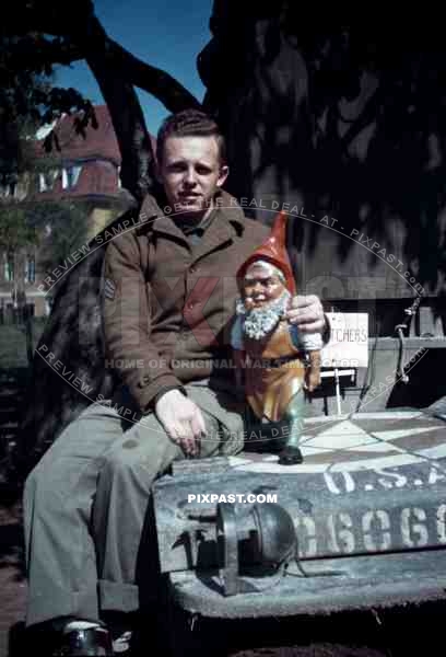 American soldier with german garden gnome. SS Childrens School in Buchenwald Germany 1945.