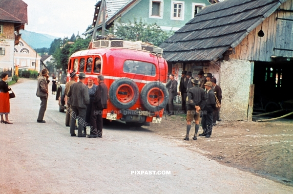 Austrian farmers getting ready to board a red Deutsche Reichspost bus. Austrian village 1939 Klagenfurt am Worthersee