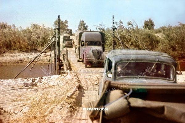 Captured French army Peugeot trucks and Opel Olympia crossing pontoon bridge Russia 1941. 297 Infantry Division