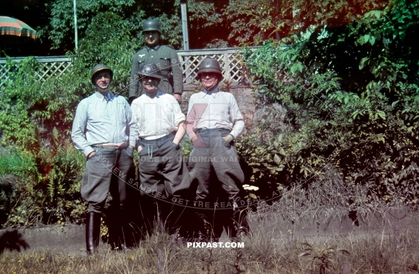 Cheeky German Wehrmacht officers wearing captured French and British steel battle helmets. France 1940.