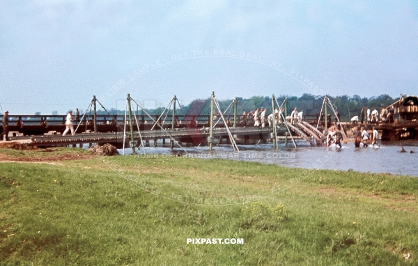 German army Pioneer unit building temporary pontoon war bridge over river. South of Paris France 1940. Blitzkrieg.