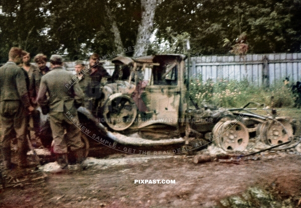 German army soldiers inspecting a burned out destroyed Russian army GAZ truck. 297 Infantry Division