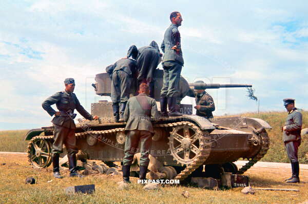German army soldiers inspecting a captured Russian Soviet T26 light panzer tank. Russia 1941