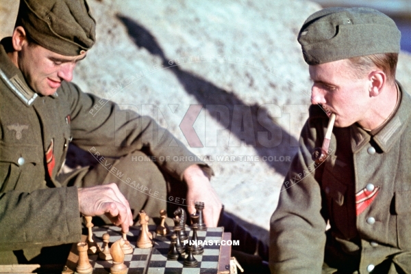 German army soldiers smoking pipe and playing chess. Ostfront ribbon. 8th Panzer Division. Russia August 1942. CHOLM