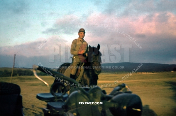 German cavalry officer on horse back passing BMW motorbike Kradmelder. Crimea Ukraine 1942