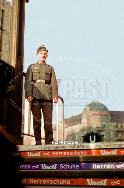 German soldier on holidays in Berlin posing at the entrance of the Berlin Ubahn station. Subway. Lingel Herrenschuhe 1939