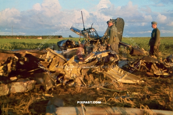 German soldiers inspecting a badly damaged crashed Luftwaffe air force Stuka dive bomber plane. France 1940