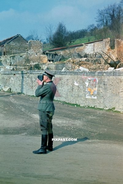 German Wehrmacht Infantry officer of the 6. Infantry Division makes a 8mm home movie film in destroyed French village 1940