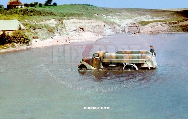 German Wehrmacht petrol tanker in green yellow camouflage driving through river in Russia 1943